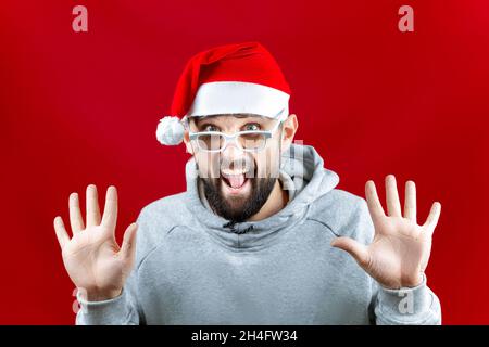 a bearded man with glasses for watching movies spread his arms to the sides and smiles broadly and with a smile Stock Photo