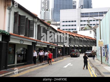 Erskine Road with old shophouses converted into restaurants, shops and hotels and modern buildings in the background in Singapore's Chinatown. Stock Photo