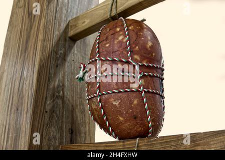 an artisanal Italian mortadella hanging in the cellar to mature Stock Photo