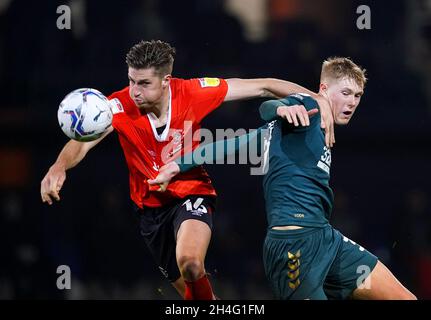 Luton Town's Reece Burke (left) and Middlesbrough's Josh Coburn battle for the ball during the Sky Bet Championship match at Kenilworth Road, Luton. Picture date: Tuesday November 2, 2021. Stock Photo