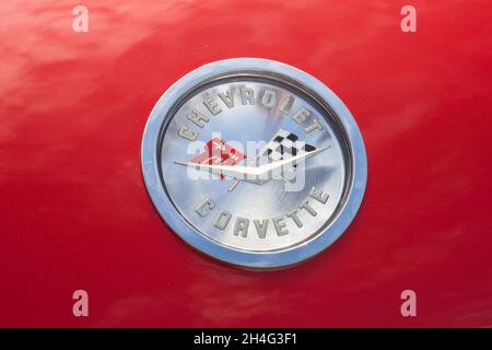 Close up detail of the logo emblem badge on the bonnet of a red American Chevrolet Corvette C1 classic sports car Stock Photo