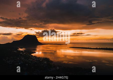 Aerial view with ocean at warm sunset time and Le Morn mountain in Mauritius Stock Photo