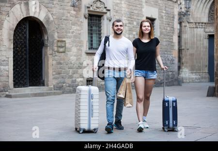 Beautiful man and woman going the historic city center Stock Photo