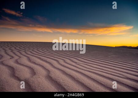 Blue and Orange Skies Over white sand dunes in White Sands National Park Stock Photo