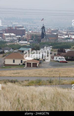 The view of Butte with mine shaft headframe and US flag on top.Butte.Montana.USA Stock Photo