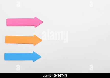 Colorful sticky notes in shape of arrows on white background Stock Photo