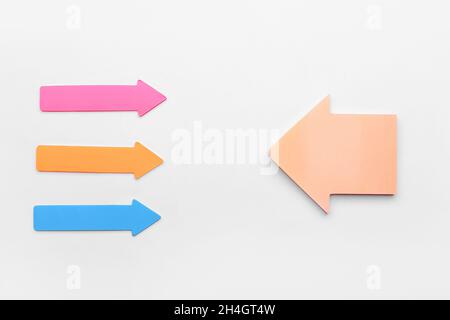 Colorful sticky notes in shape of arrows on white background Stock Photo