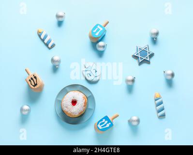 Symbols of Hanukkah with Christmas decor on color background Stock Photo