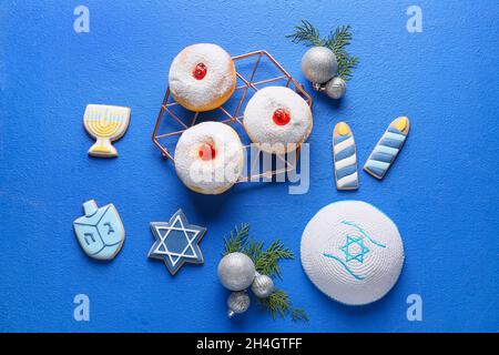 Symbols of Hanukkah with Christmas decor on color background Stock Photo