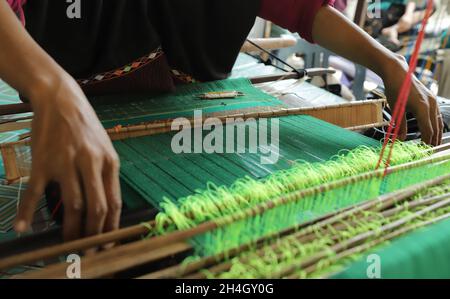 close up of hands doing weaving work using traditional tools Stock Photo