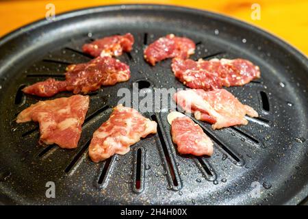 Close-up of grilled pork belly on Korean barbecue grill pan Stock Photo