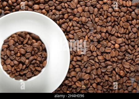 White coffee mug filled with coffee beans Stock Photo