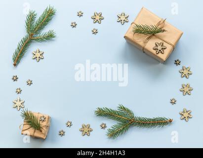 Christmas composition. New year, holiday gifts, fir branches, decorative snowflakes on the blue background.  Stock Photo