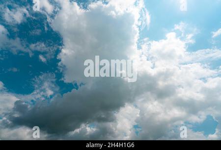 Beautiful blue sky and white cumulus clouds abstract background. Cloudscape background. Blue sky and fluffy white clouds on sunny day. Nature weather. Stock Photo