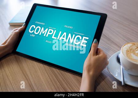 Compliance concept with icons and diagrams. Regulations, law, standards, requirements, audit. Concept on device screen.