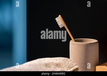 Closeup to Wood Toothbrush in the mug and in front of black background. Stock Photo