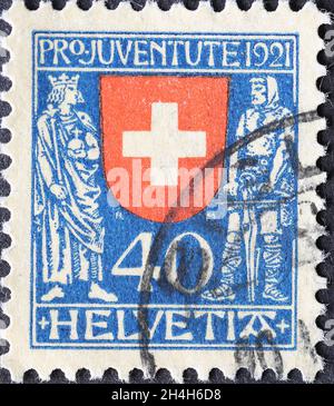 Switzerland - Circa 1921: a postage stamp printed in the Switzerland showing the historical coat of arms of Switzerland with the emperor and Wilhelm T Stock Photo