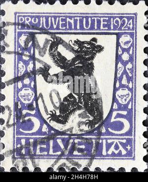 Switzerland - Circa 1924: a postage stamp printed in the Switzerland showing a black bear on the coat of arms of the Swiss canton of Appenzell Inner R Stock Photo