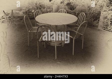 Table and chairs in a garden, Cotes-d'Armor, Brittany, France Stock Photo