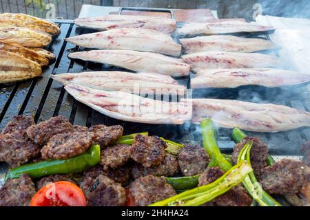 Grilled mackerel in a street market in Istanbul. Grilled mackerel also known as Balik Ekmek traditional turkish sandwich with fish Stock Photo