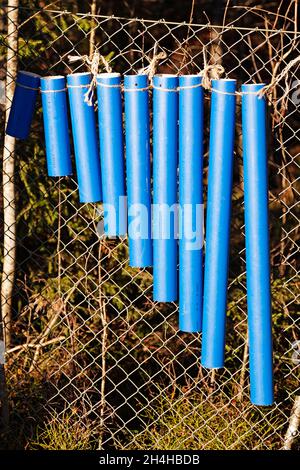old blue plastic pipes that have been turned into musical instruments Stock Photo