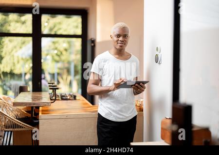Latin man choosing temperature on thermostat Stock Photo