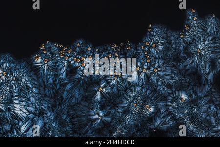 Extreme macro photograph of Vitamin C crystals forming abstract modern art patterns, when illuminated with polarized light, flowers pattern design Stock Photo