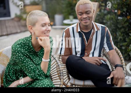 Multiracial couple having dinner at their backyard Stock Photo