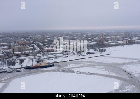 Arkhangelsk, Russia - January 7, 2021:The city on river bank, in the winter, is photographed from above. Stock Photo