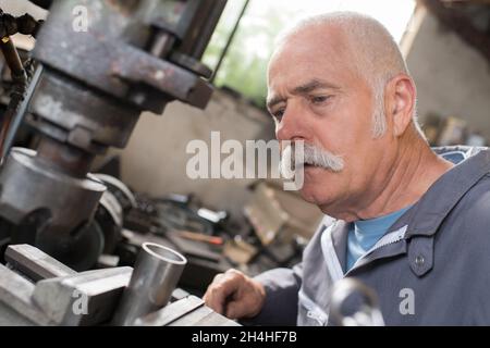 worker serves a cnc milling machine in mechanical engineering Stock Photo