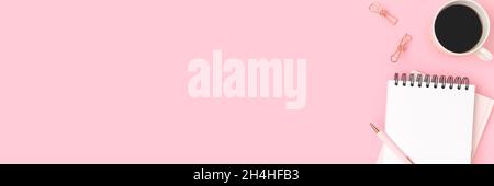Banner with blank notepad, stationery and coffee cup on a pink background. Workspace with place for text. Stock Photo