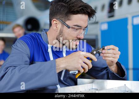 portrait of handsome smiling auto mechanic in blue overall Stock Photo