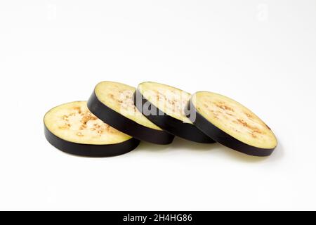 fresh and raw sliced purple eggplant isolated on white background, organic vegetables, creative concept, healthy food Stock Photo