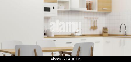 Minimalist white dining room with dining table set and comfy clean kitchen space in the background. 3d rendering, 3d illustration Stock Photo