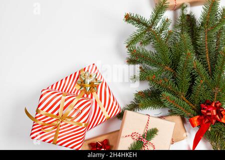 Christmas composition. Pine tree branches, christmas gift boxes decorations on colored background. Top view, copy space for text Stock Photo