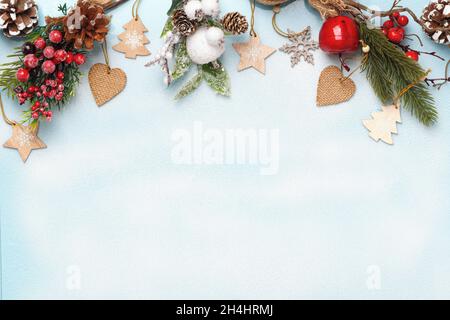Christmas composition. Spruce branches with cones on a snowy white background. Frame border flat lay top view copy space Stock Photo