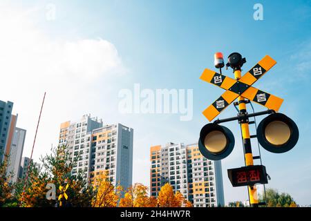 Hangdong Railroad crossing signal railroad barrier at autumn in Seoul, Korea Stock Photo