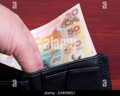 Papua New Guinean money - kina in the black wallet Stock Photo