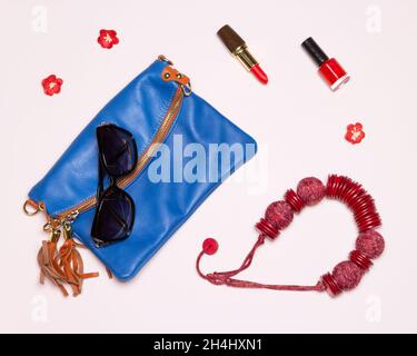 Fashion women accessories. Mini bag, sunglasses, necklace, red lipstick and nail polish Stock Photo