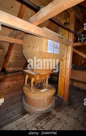 Mureck, Austria - September 24, 2021: Inside old ship mill, filling container and feed to the grinder with description of the work process Stock Photo