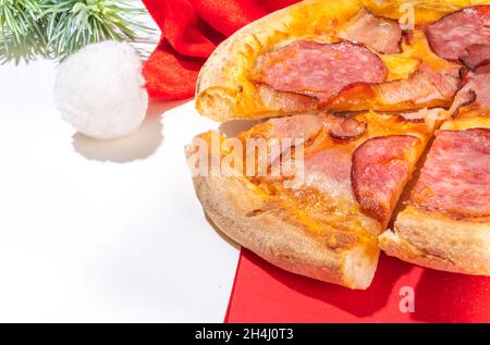 Christmas decorated background with pepperoni and mushrooms pizza, Delivery and restaurant Xmas Lunch and party menu, Santa delivers pizza for Christm Stock Photo