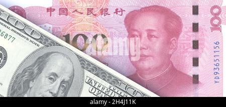 Chinese Yuan and US dollars banknotes background. China and United States America paper currencies. Trade and commerce concept Stock Photo