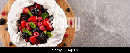 Delicious Pavlova cake with meringue topped and fresh berries Stock Photo