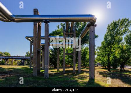 Steel pipelines outgoing from the plant at sunny day. Stock Photo