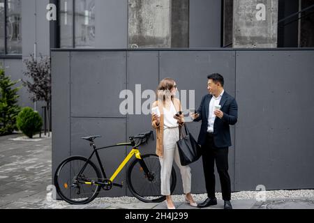 Business people drinking coffee and using phones Stock Photo