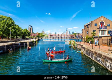 People canoeing in a canoe slalom at the Shadwell Basin Outdoor Activity Centre, London, UK