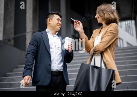 People smoking cigarettes during break at work Stock Photo