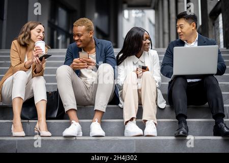 Business team talking and using digital devices Stock Photo