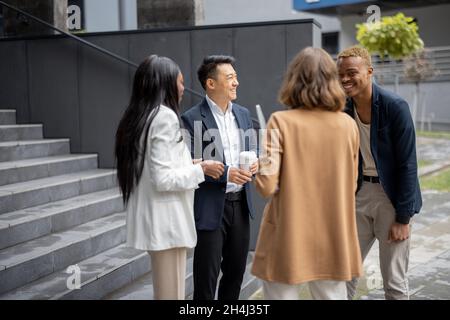 Multiracial business team talking on city street Stock Photo