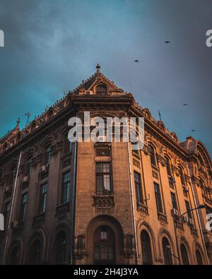 BUCHAREST, ROMANIA - Sep 01, 2021: An old building with unique architecture against the cloudy sky Stock Photo